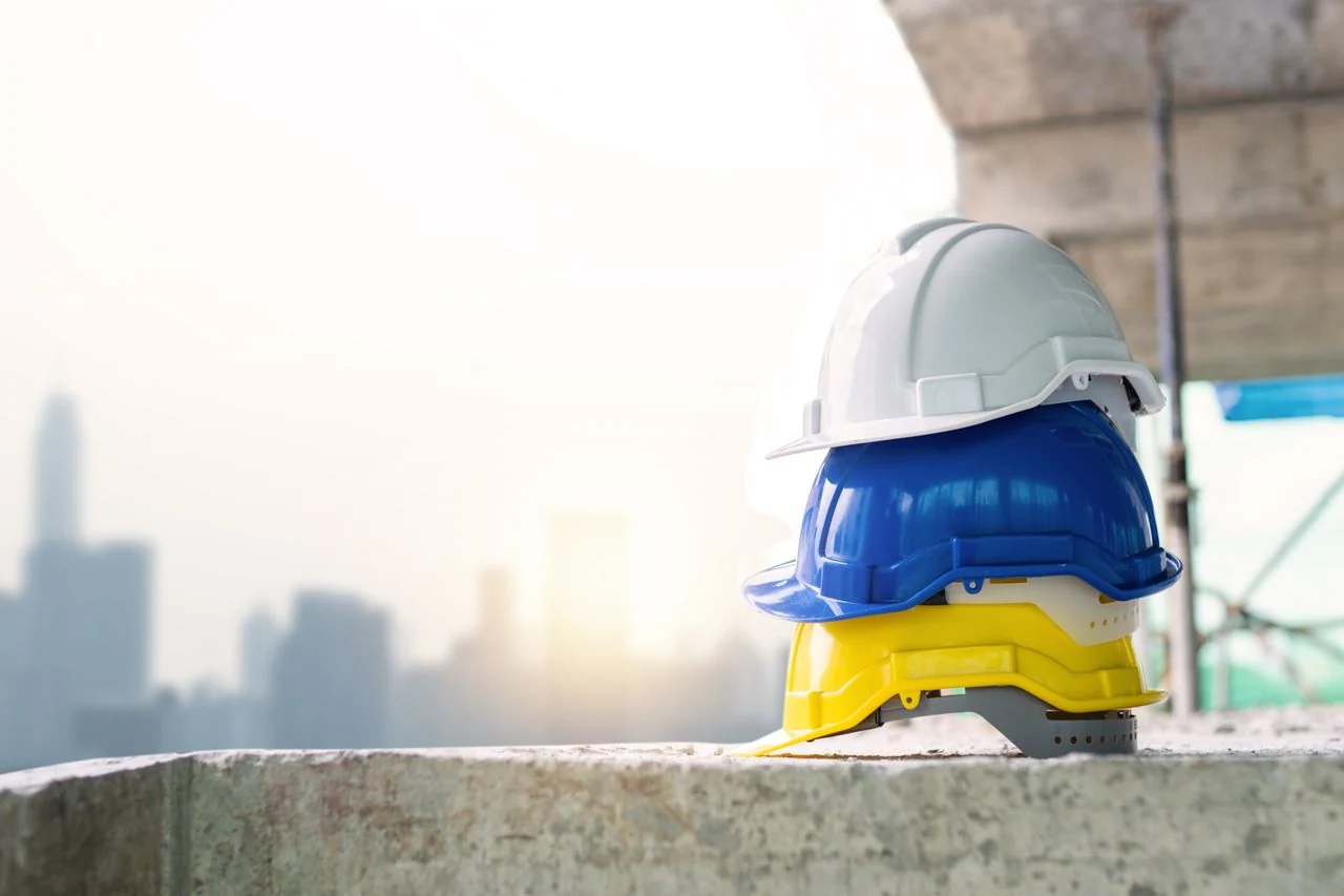 Stack of construction safety helmets on site