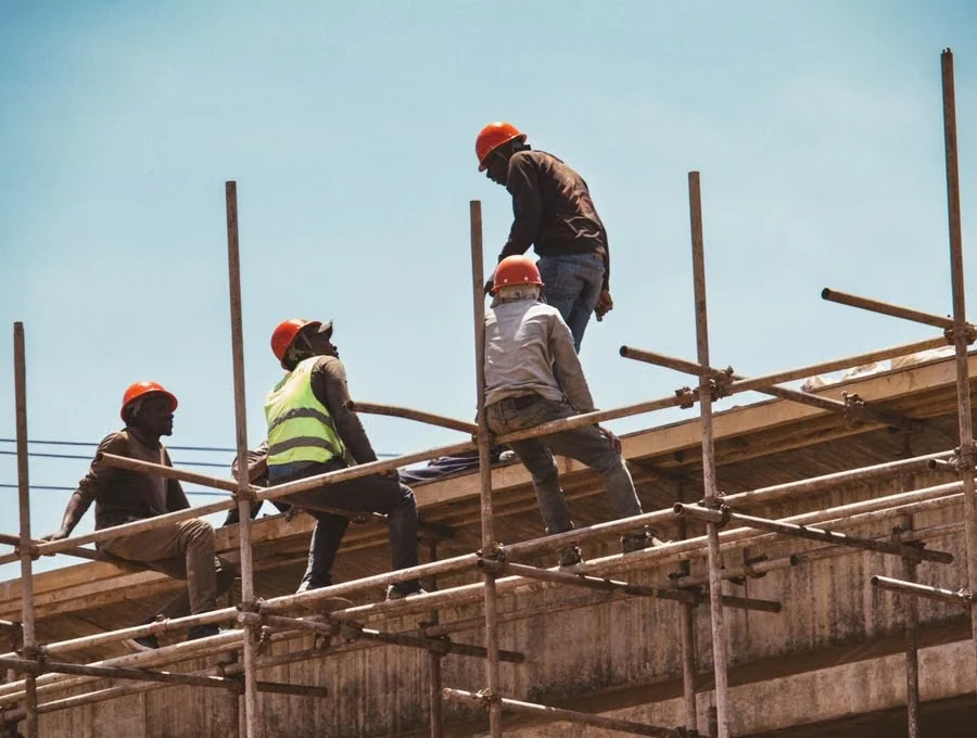Construction workers on scaffolding at a bridge waterproofing site