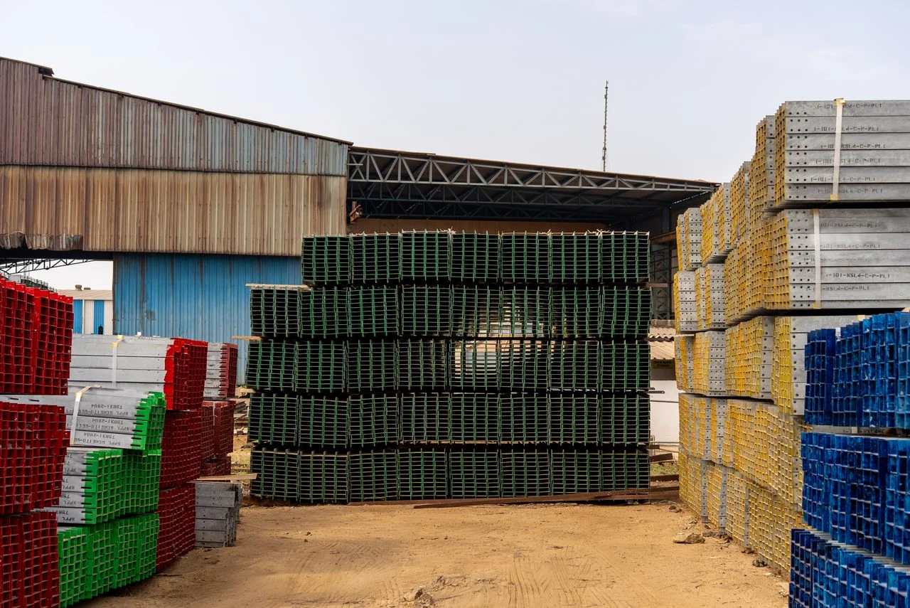 Stacked construction formwork and equipment supplies at a storage yard